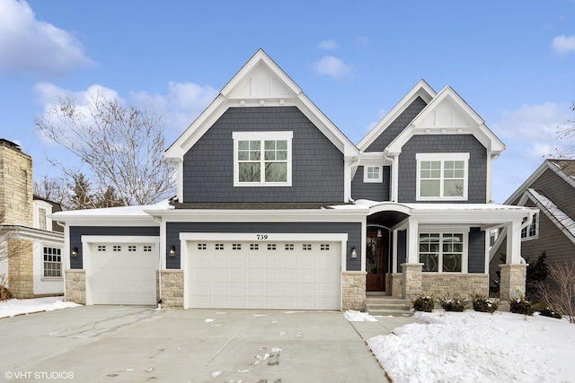 view of front of house with stone siding and driveway