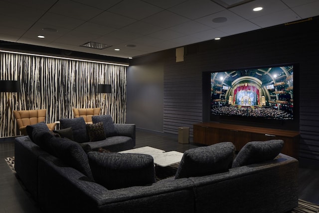 home theater with a paneled ceiling and dark wood-type flooring