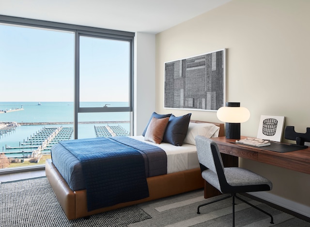 carpeted bedroom featuring a water view, multiple windows, and a wall of windows