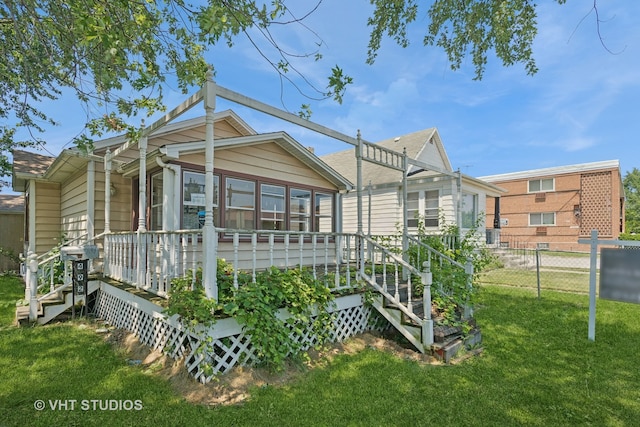 rear view of property with a lawn