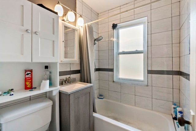 full bathroom with toilet, shower / tub combo with curtain, and vanity