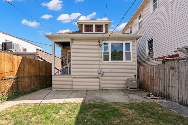 rear view of property featuring central air condition unit and a patio area