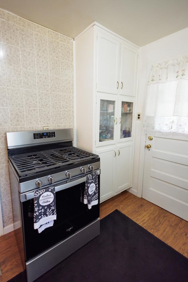 kitchen featuring white cabinetry, hardwood / wood-style flooring, and stainless steel range with gas stovetop