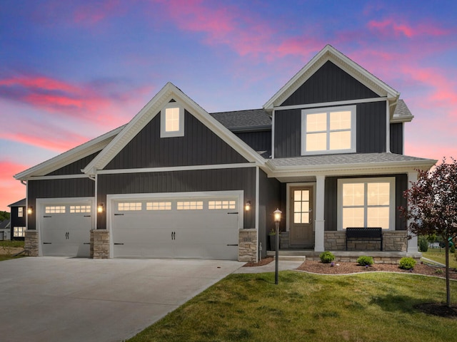 craftsman inspired home featuring a yard, covered porch, and a garage