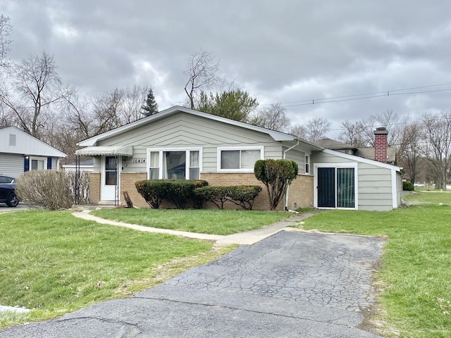 16404 Homan Ave, Markham, IL 60428 - bungalow-style house featuring a front yard, brick siding, and a chimney