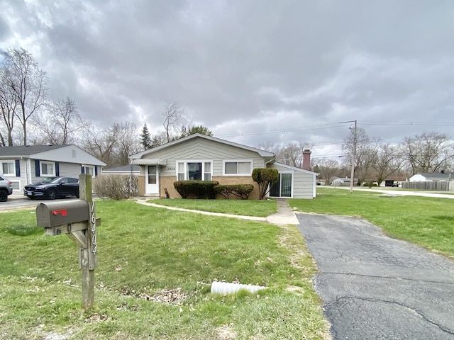 16404 Homan Ave, Markham, IL 60428 - bungalow with aphalt driveway, brick siding, and a front lawn
