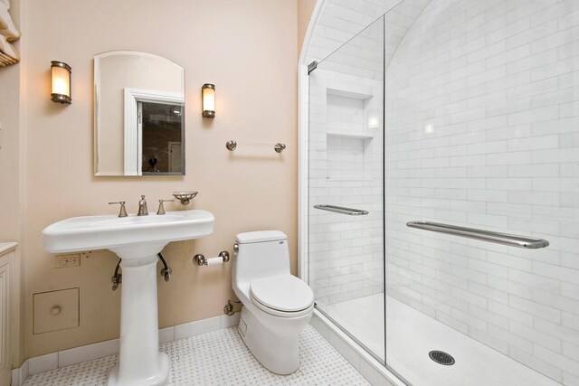 bathroom featuring an enclosed shower, tile patterned floors, and toilet