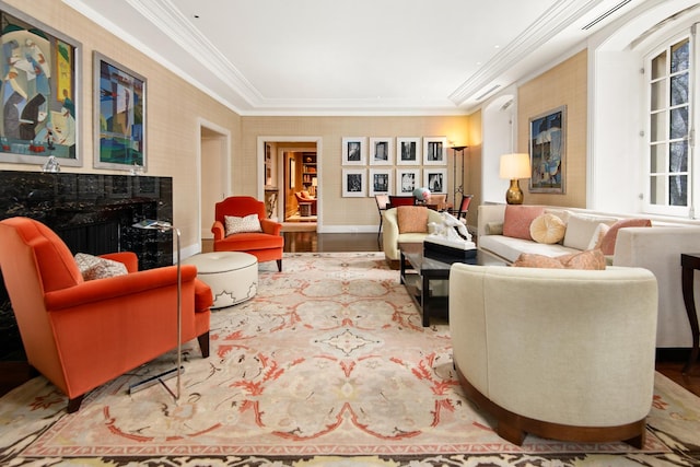 living room with hardwood / wood-style floors, crown molding, and a premium fireplace