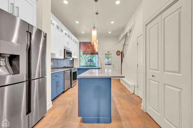 kitchen with white cabinetry, blue cabinets, and stainless steel appliances