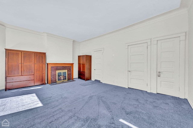 unfurnished living room with a fireplace, dark carpet, and ornamental molding