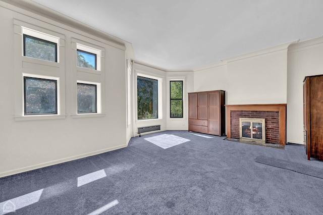 unfurnished living room featuring crown molding, a brick fireplace, and carpet floors