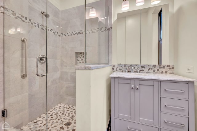 bathroom featuring walk in shower and vanity