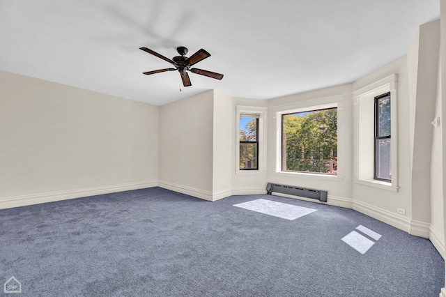 spare room with carpet floors, a baseboard heating unit, and ceiling fan