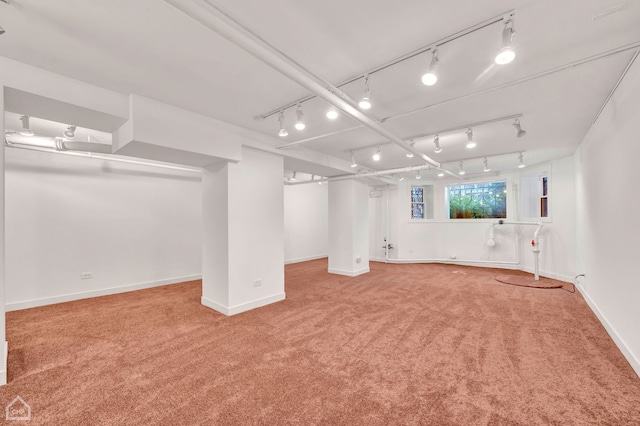 basement featuring carpet flooring and track lighting