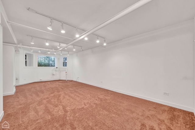 spare room with carpet flooring and track lighting