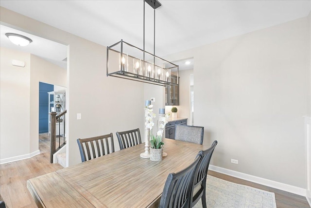 dining area with light wood finished floors and baseboards