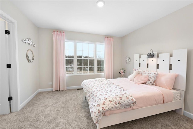 bedroom with light carpet and baseboards