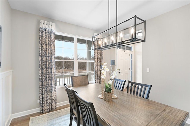 dining space featuring wood finished floors and baseboards