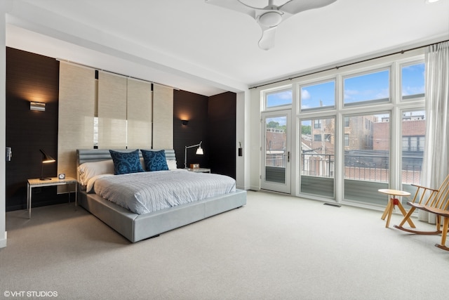 carpeted bedroom featuring access to outside and ceiling fan