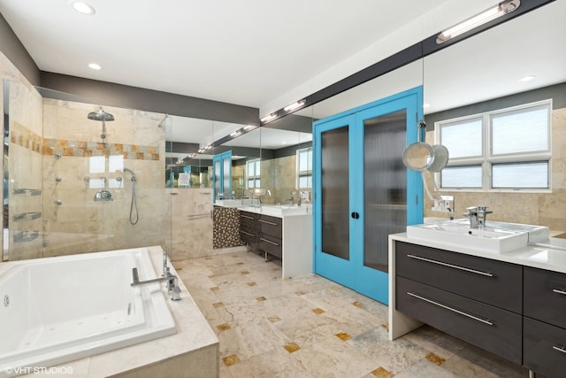 bathroom featuring tile patterned flooring, shower with separate bathtub, french doors, and dual bowl vanity