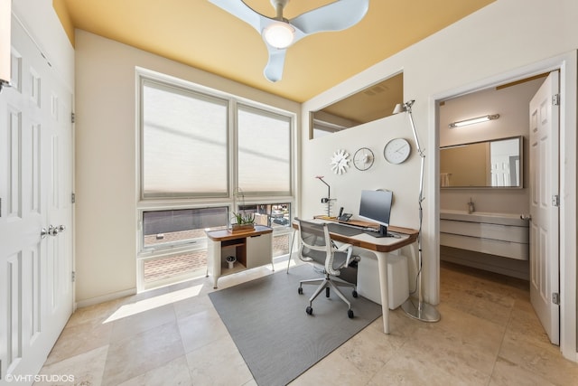 tiled office space featuring ceiling fan