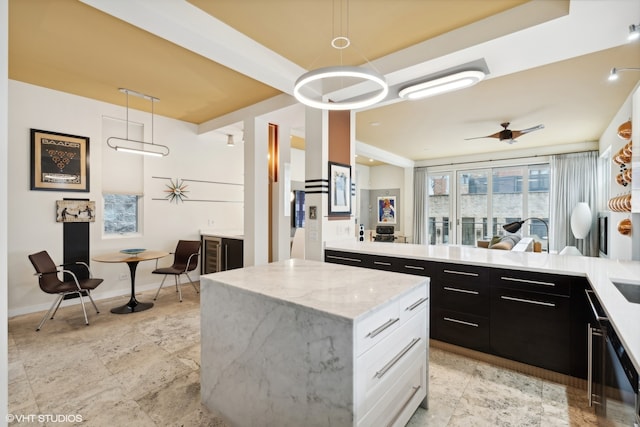 kitchen featuring white cabinets, hanging light fixtures, light tile patterned floors, and ceiling fan