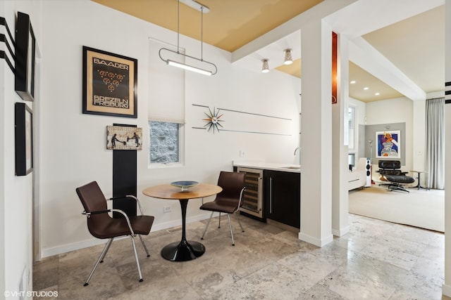 tiled dining space featuring sink and beverage cooler