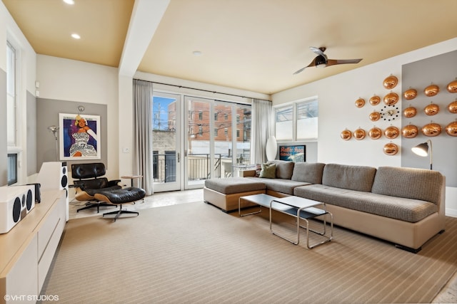 carpeted living room featuring ceiling fan and a healthy amount of sunlight