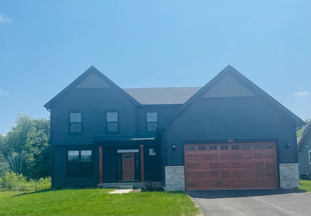 view of front of property featuring a garage and a front lawn