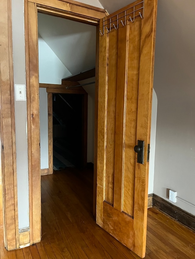 hallway with dark hardwood / wood-style floors