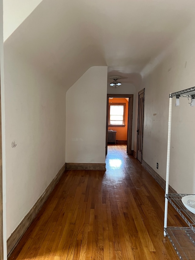 bonus room with vaulted ceiling, ceiling fan, wood-type flooring, and radiator