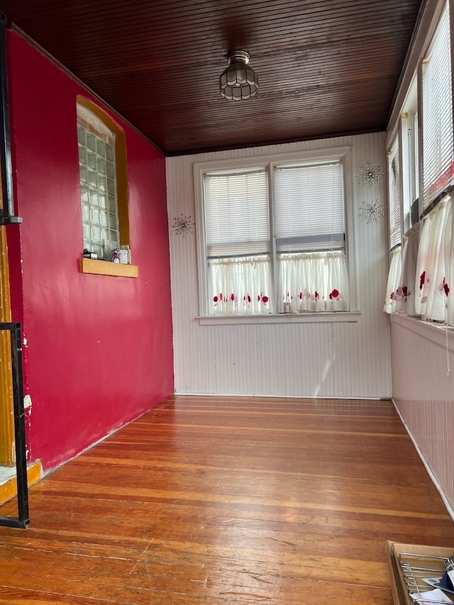 spare room featuring wooden ceiling and wood-type flooring