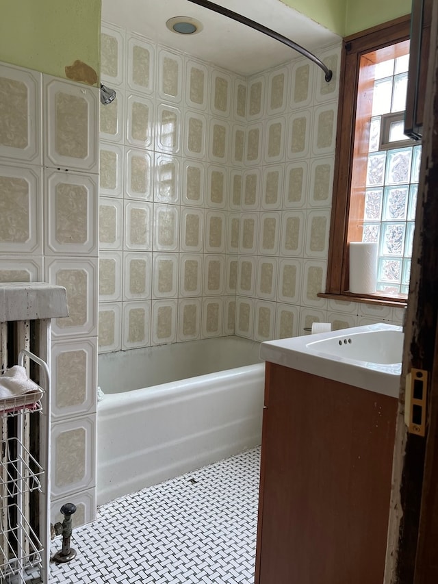 bathroom featuring bathing tub / shower combination, a wealth of natural light, and vanity