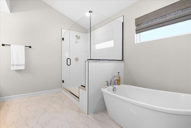 full bathroom with baseboards, lofted ceiling, marble finish floor, a freestanding bath, and a shower stall