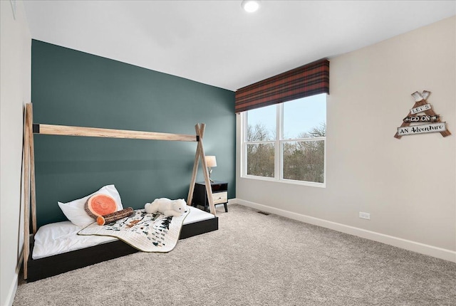 carpeted bedroom featuring visible vents and baseboards