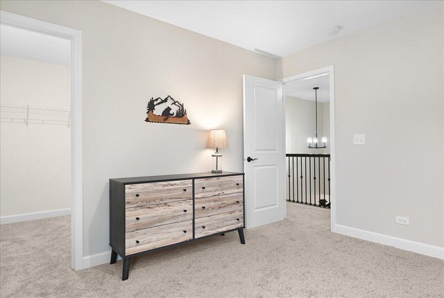 bedroom with carpet floors and an inviting chandelier