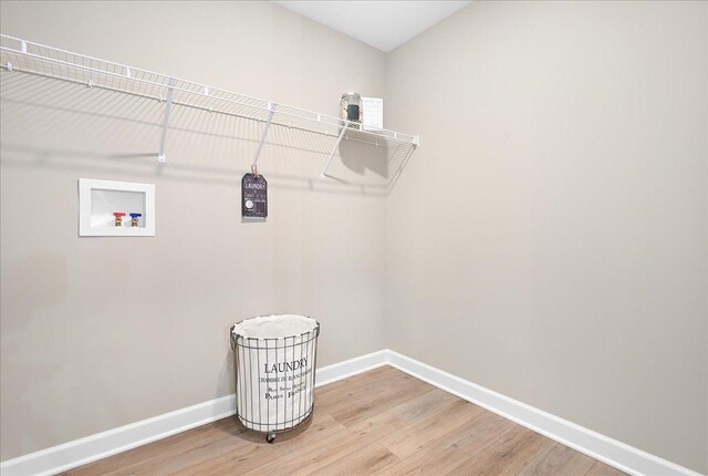 laundry area with light wood-type flooring and washer hookup