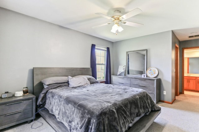 carpeted bedroom featuring ceiling fan and ensuite bathroom