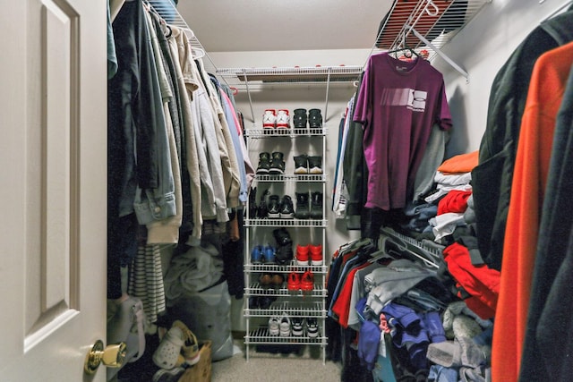 walk in closet with carpet