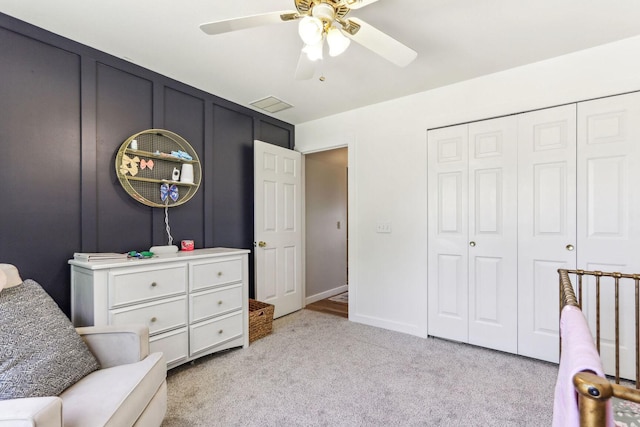 sitting room featuring light carpet and ceiling fan