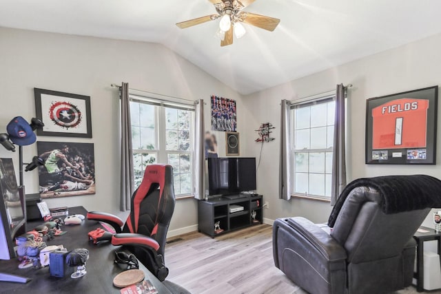 office area featuring light hardwood / wood-style floors, vaulted ceiling, and ceiling fan