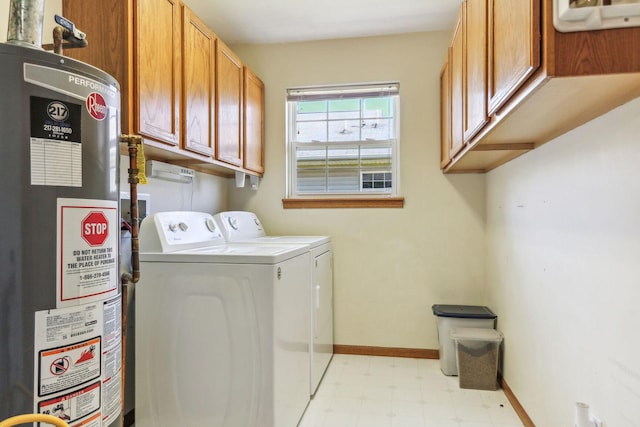 laundry area with washing machine and dryer, water heater, and cabinets