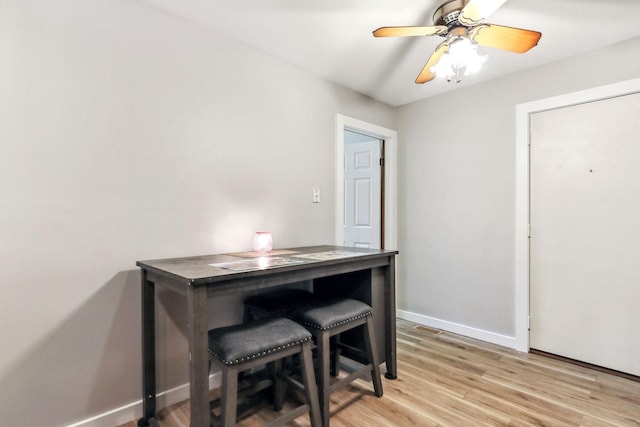 dining space featuring light wood-type flooring and ceiling fan