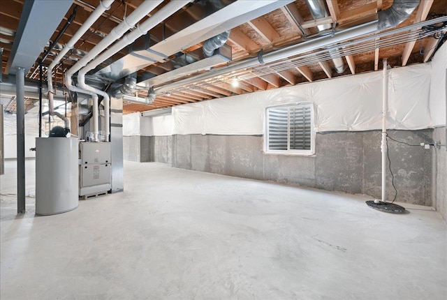 unfinished basement featuring water heater and heating unit