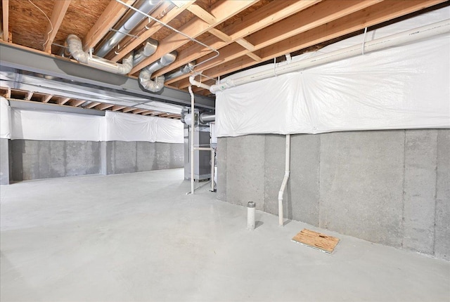 unfinished basement featuring heating unit