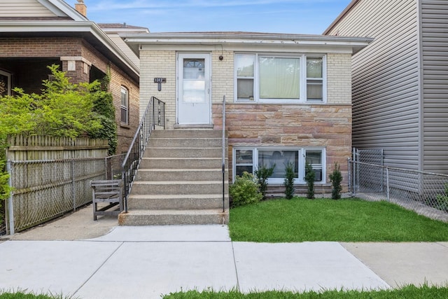 view of exterior entry with a lawn