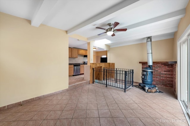 tiled living room featuring a wood stove, beam ceiling, and ceiling fan