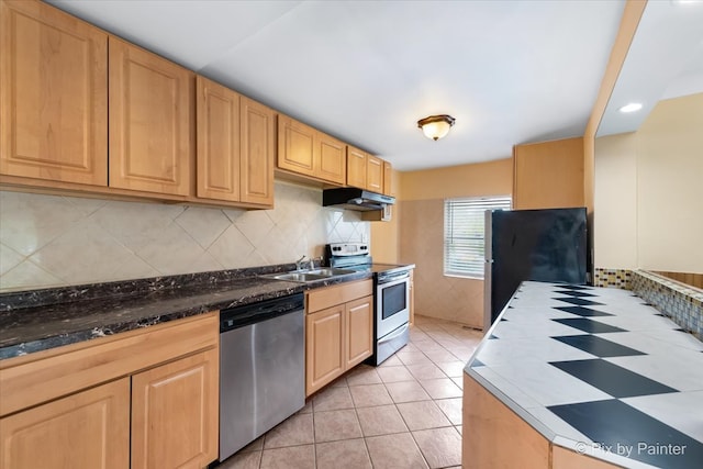 kitchen featuring light tile patterned flooring, dishwasher, backsplash, electric range oven, and black fridge