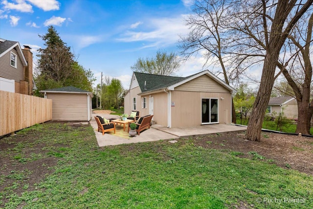 back of property with a patio, fence, an outdoor structure, a storage shed, and a lawn