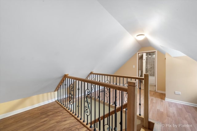 interior space featuring wood-type flooring and vaulted ceiling